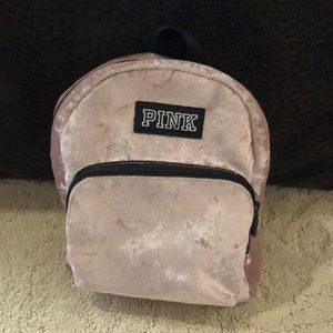 A PINK mini backpack in the color rose gold